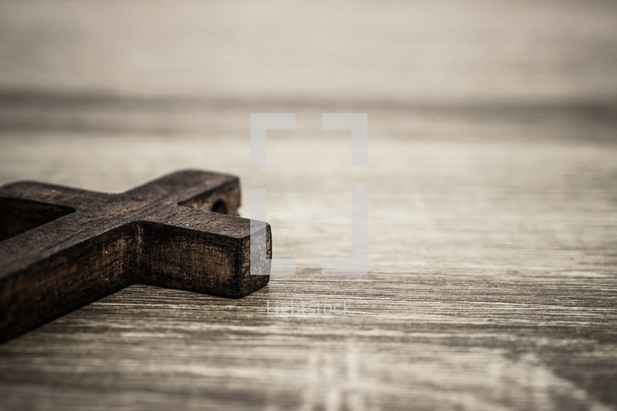 wood cross on a wood table 