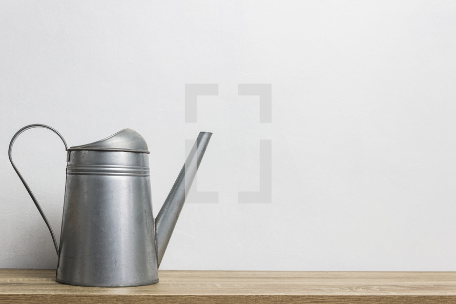 watering can against a white background 