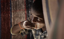 Child in central India eating rice.