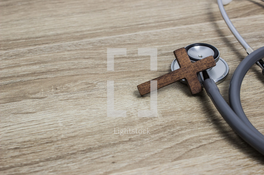 wooden cross and stethoscope 