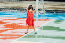 toddler on a wet soccer field 