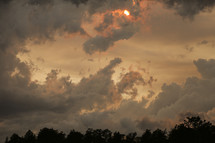 sun peeking through a cloudy sky 