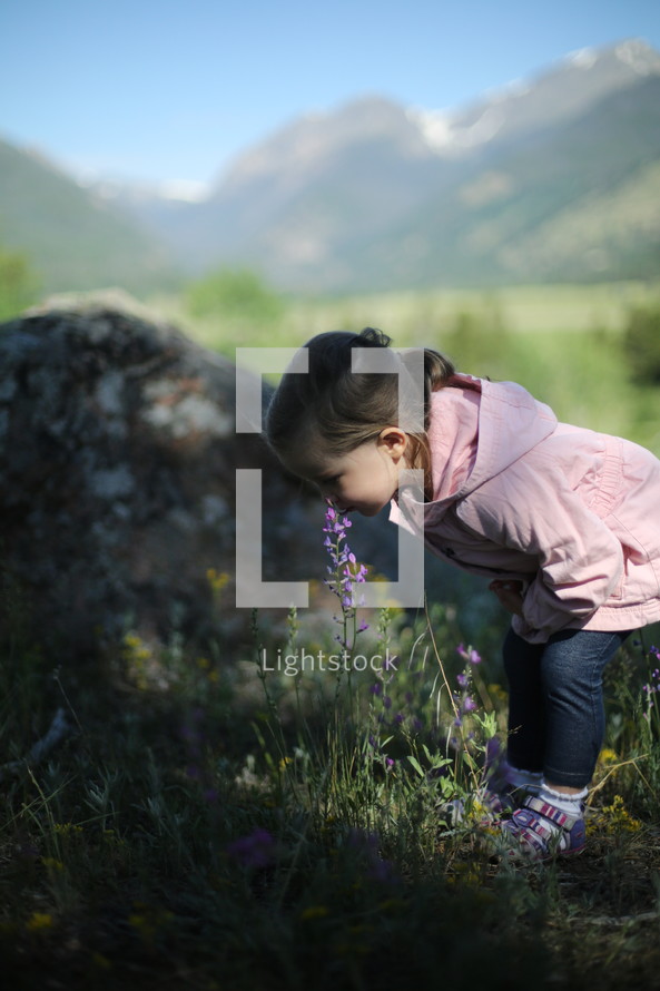 child smelling a flower 