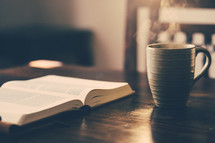open Bible and a coffee mug