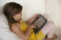 little girl using a tablet 
