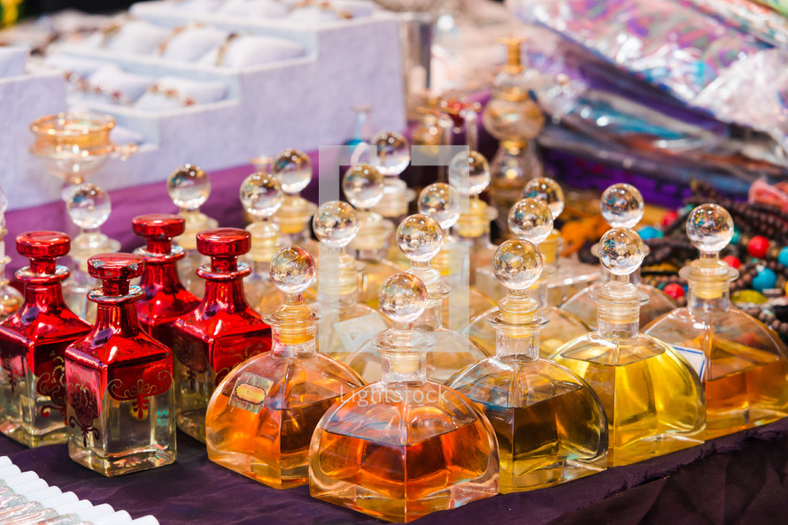 Arabian perfumes in  bottles at market. oil and rose flowers aromatherapy spa perfumery.