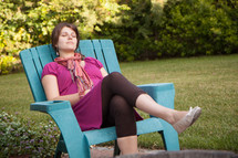 woman resting in a chair outdoors 