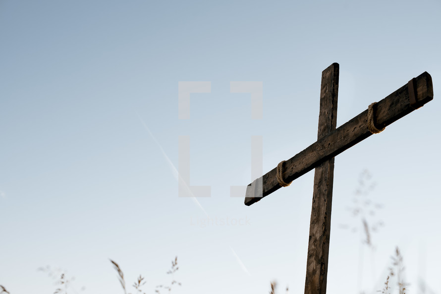 a wooden cross in a field 