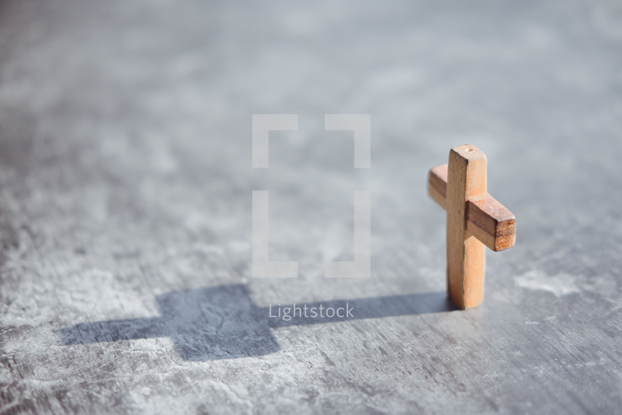 small wooden cross with shadow 