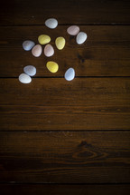 candy eggs on a wood background 