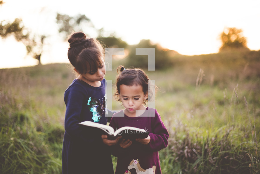 sisters reading a Bible 