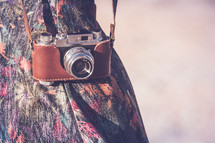 vintage camera in a case over a woman's arm 