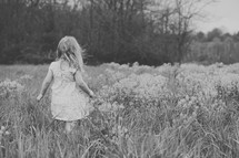 A child in a field of flowers.