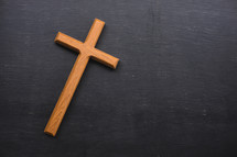 wooden cross on a slate background 