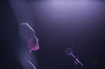 Woman at a microphone.