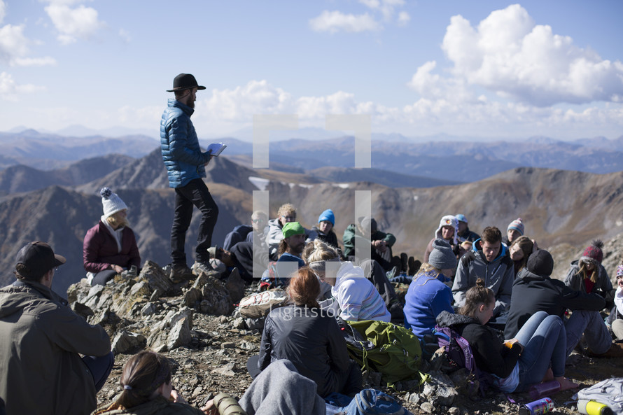 group resting on a mountaintop 