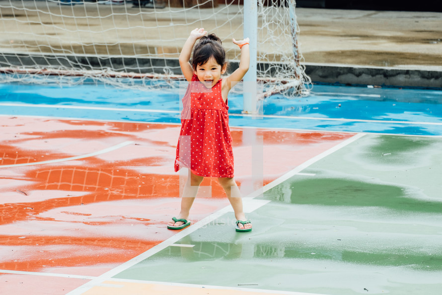 toddler on a wet soccer field 