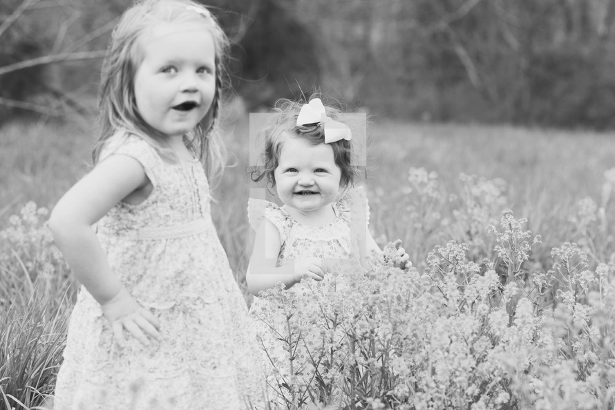 Two small children in a field of flowers.