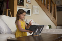 a child learning on a tablet - online school 