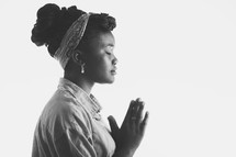 woman in prayer with white background.