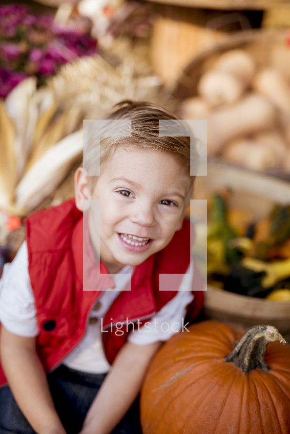 smiling boy with a pumpkin 