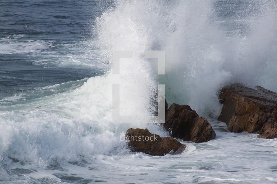 waves crashing into rocks 