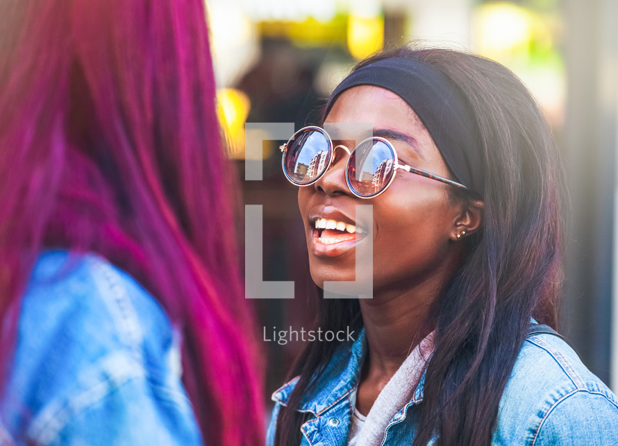 Young adult woman with sunglasses smiling