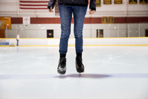 woman in ice skates standing on an ice rink 