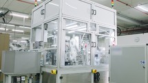 Advanced robots placing parts in an automated assembly line