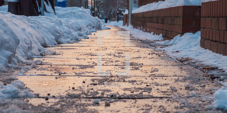 shoveled sidewalk after a snow storm 
