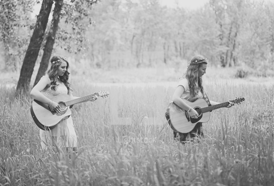 2 girls out in nature playing and singing