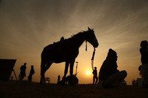 silhouette of a horse and film crew 