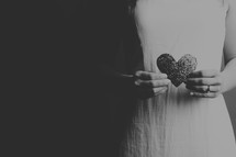 Woman holding a glittery heart.