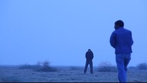 men walking through a desert 