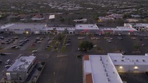 Aerial of a small town shopping center at dusk