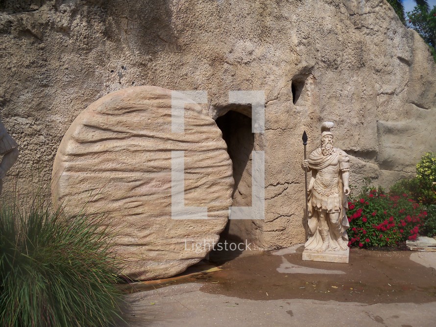  The empty tomb of Jesus with the roman seal broken and the stone rolled away showing an empty tomb and a resurrected Christ who cannot be held by the grave, death or hell. Very realistic photo of the tomb of Jesus with a roman soldier statue as a reminder that all the armies in the world cannot stop the resurrection of Jesus. During the time of Jesus death, Rome was worried that the Jews would try to steal the body of Jesus to validate rumours of Christ being resurrected from the tomb.
