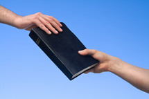 hands holding a Bible