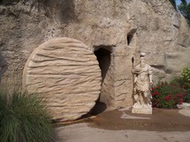  The empty tomb of Jesus with the roman seal broken and the stone rolled away showing an empty tomb and a resurrected Christ who cannot be held by the grave, death or hell. Very realistic photo of the tomb of Jesus with a roman soldier statue as a reminder that all the armies in the world cannot stop the resurrection of Jesus. During the time of Jesus death, Rome was worried that the Jews would try to steal the body of Jesus to validate rumours of Christ being resurrected from the tomb.