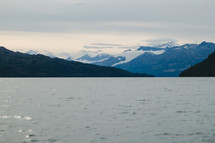 snow capped mountain peaks and sea water 