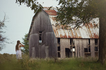 woman and an old weathered barn 