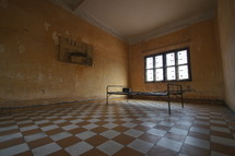 Lone bed in an empty prison room