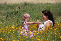 Mother and daughter in field of flowers - Mother's Day