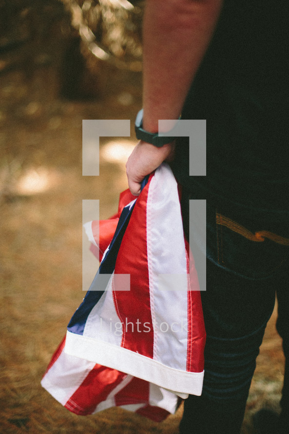 Carrying a folded American flag.