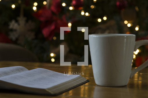 Mug and open bible on a coffee table and... — Photo — Lightstock