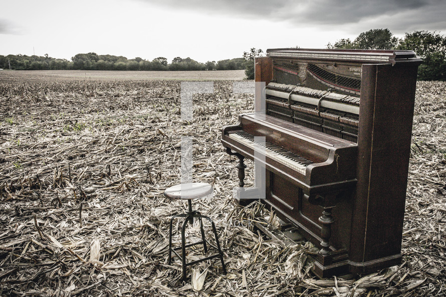  a piano in a plowed field 
