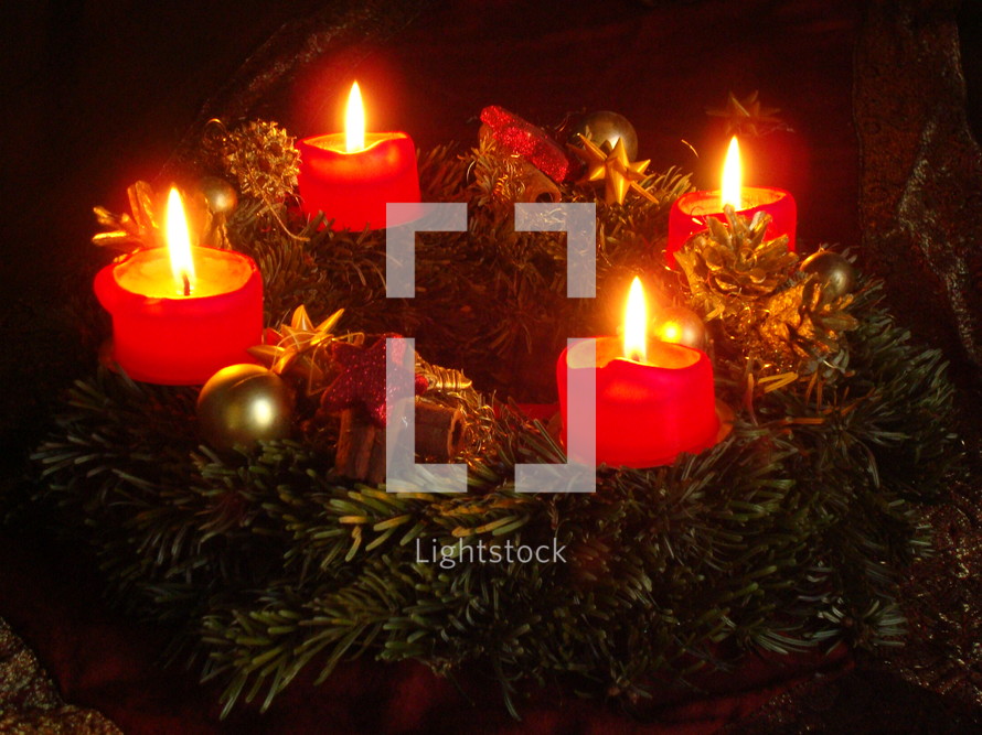 Advent candle wreath with four burning candles