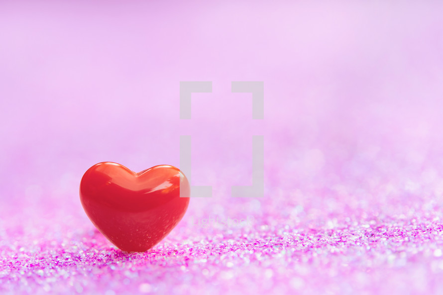 one red heart on a pink background 