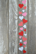 paper hearts on a weathered wood background 