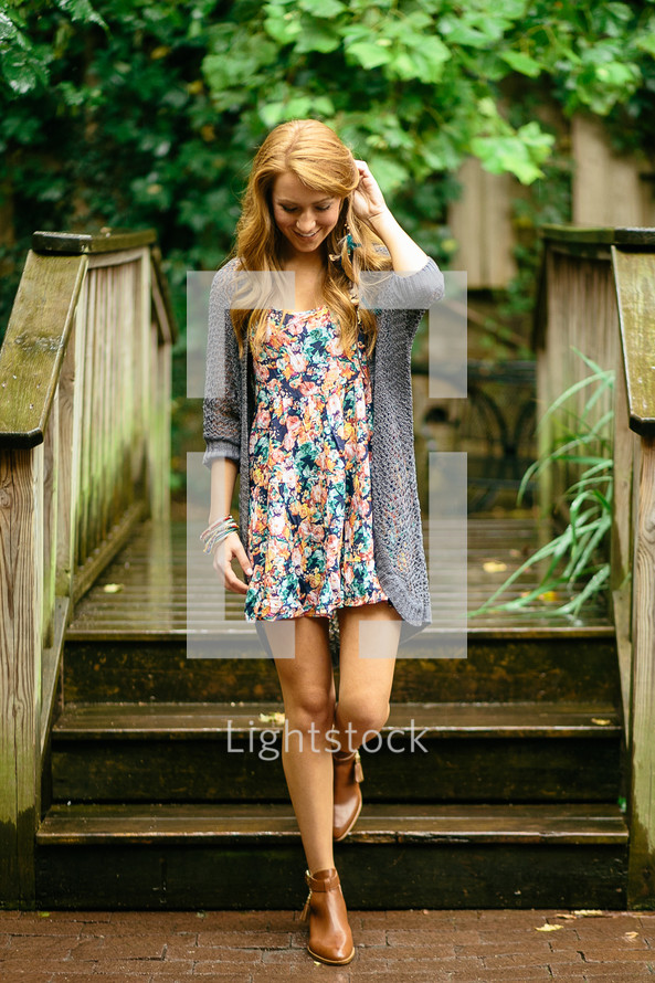 a young woman walking down steps 