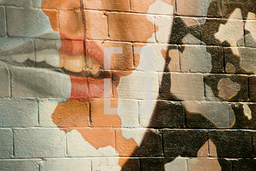 lips painting on a brick wall 